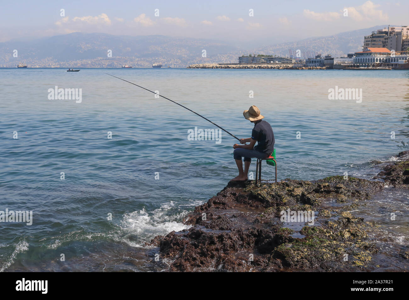 October 6, 2019, Beirut, Lebanon: A man fishing at the seafront during the hot and humid day in Beirut. (Credit Image: © Amer Ghazzal/SOPA Images via ZUMA Wire) Stock Photo
