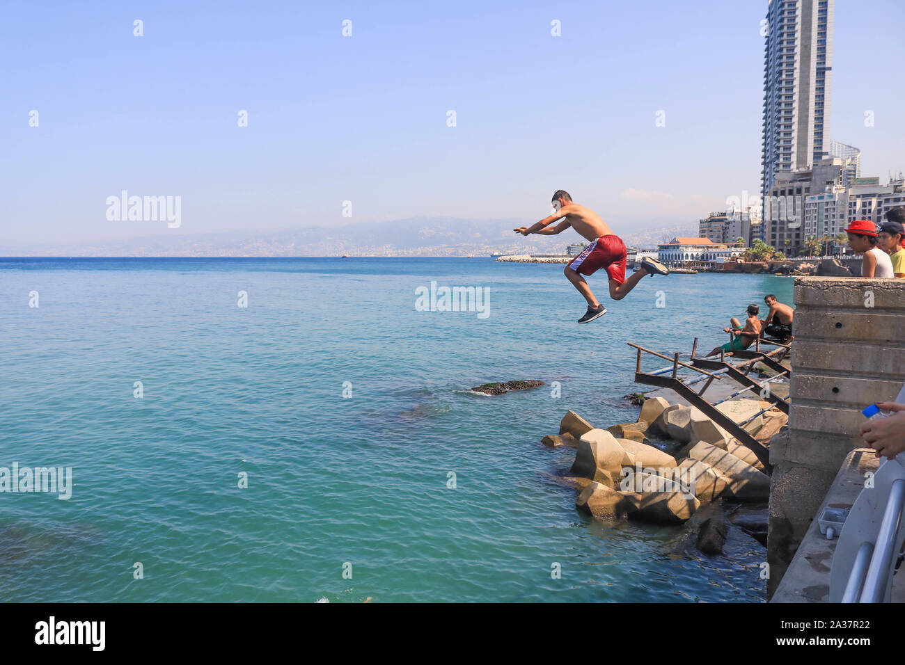 October 6, 2019, Beirut, Lebanon: A man dives into the sea during the hot and humid day in Beirut. (Credit Image: © Amer Ghazzal/SOPA Images via ZUMA Wire) Stock Photo