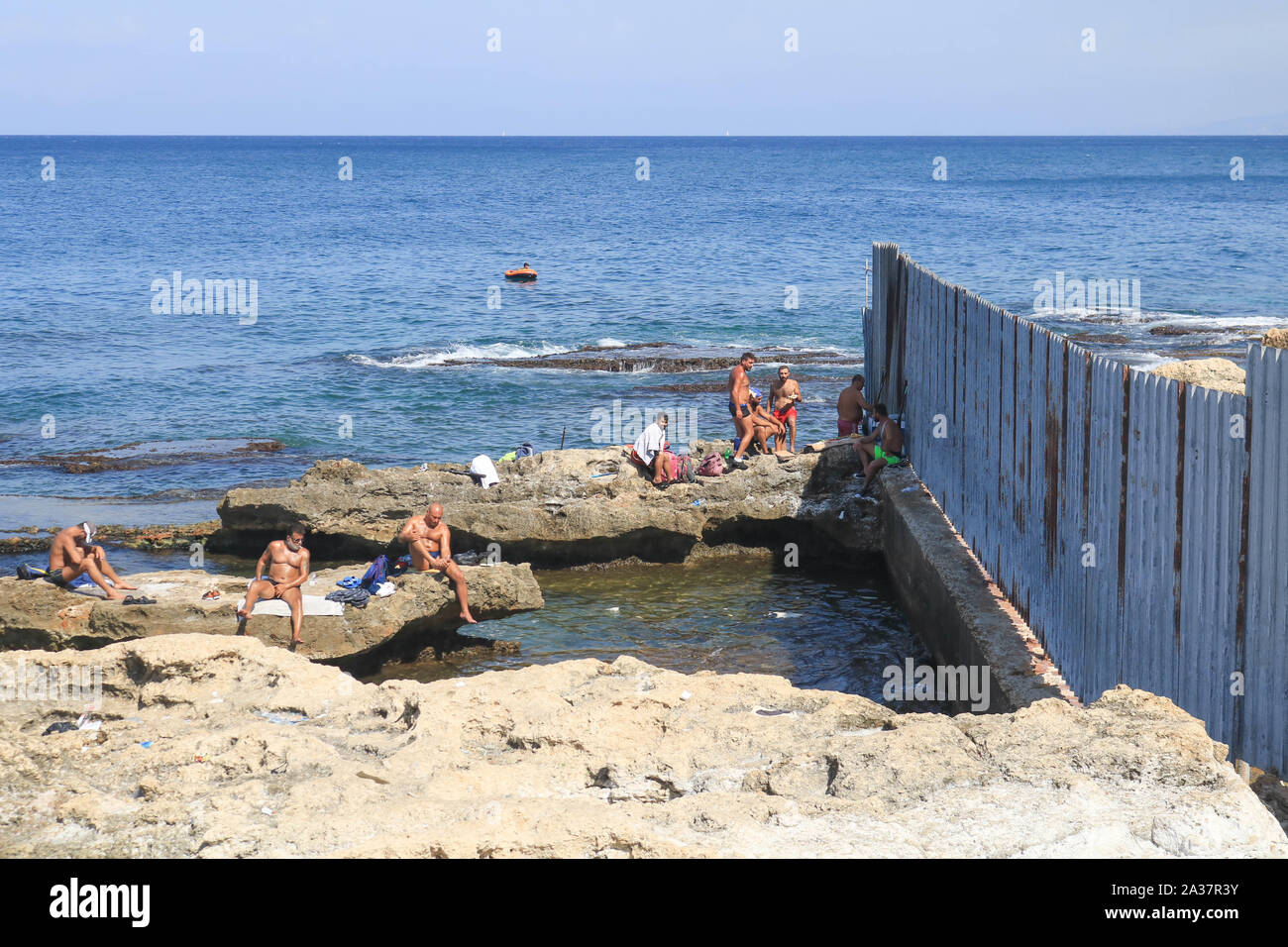 October 6, 2019, Beirut, Lebanon: People at the rocky seafront of the sea during the hot and humid day in Beirut. (Credit Image: © Amer Ghazzal/SOPA Images via ZUMA Wire) Stock Photo