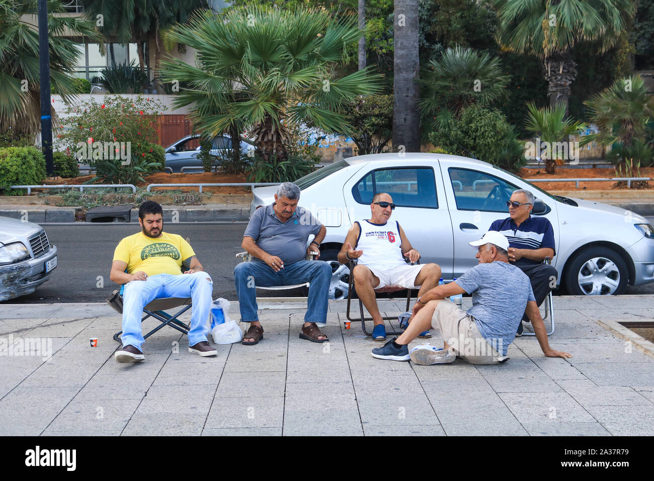 October 6, 2019, Beirut, Lebanon: Men sheltering in a shade during the hot and humid day in Beirut. (Credit Image: © Amer Ghazzal/SOPA Images via ZUMA Wire) Stock Photo