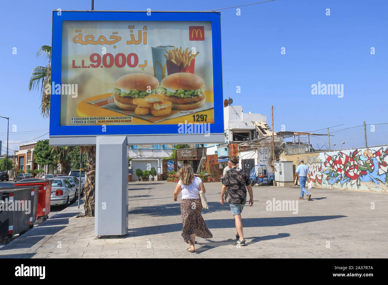 October 6, 2019, Beirut, Lebanon: Pedestrians walk past a McDonalds chicken burgers advertising board in Beirut. (Credit Image: © Amer Ghazzal/SOPA Images via ZUMA Wire) Stock Photo