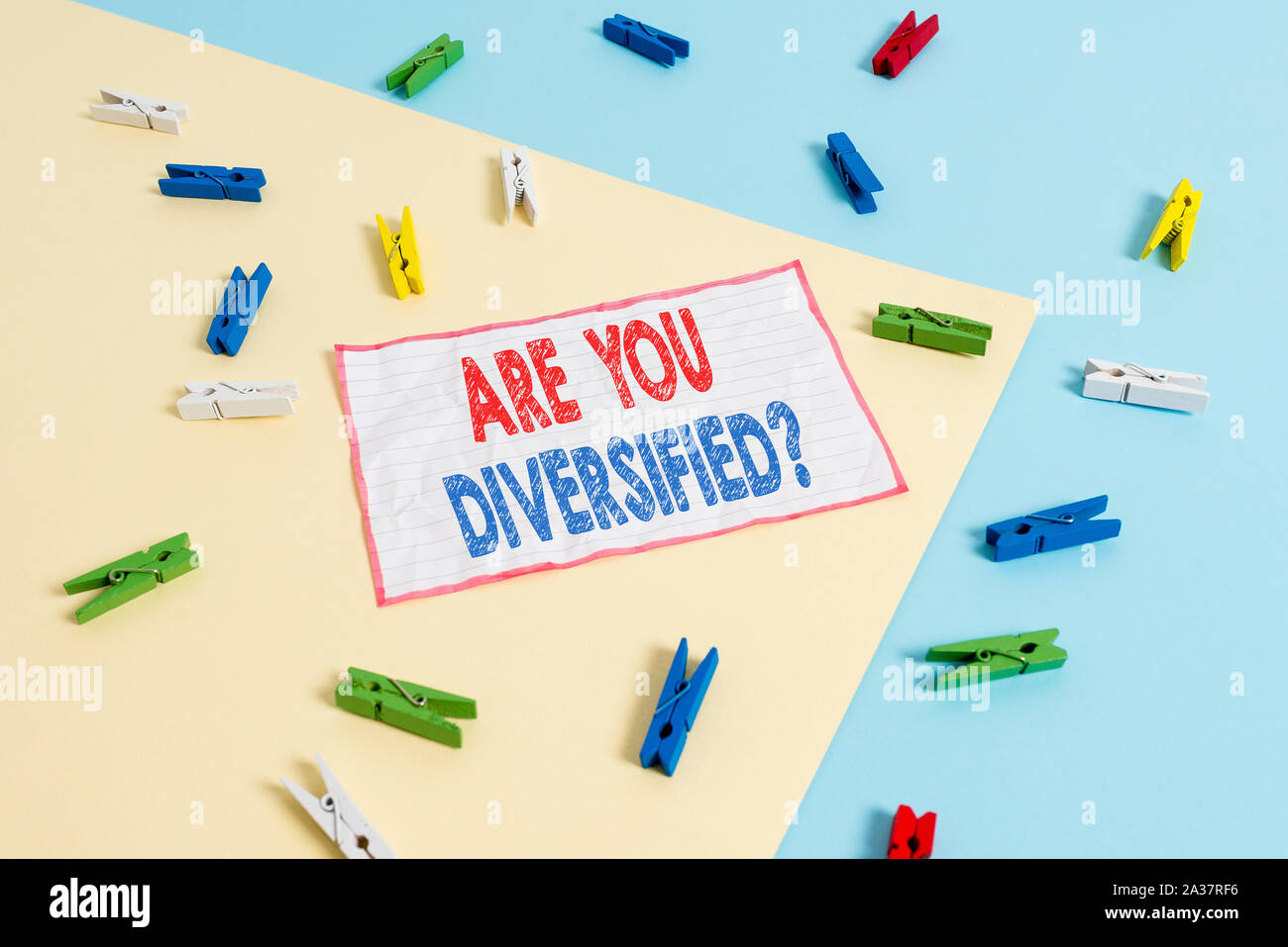 Conceptual hand writing showing Are You Diversified Question. Concept meaning someone who is Different Mixed Multi Faceted Colored clothespin paper re Stock Photo