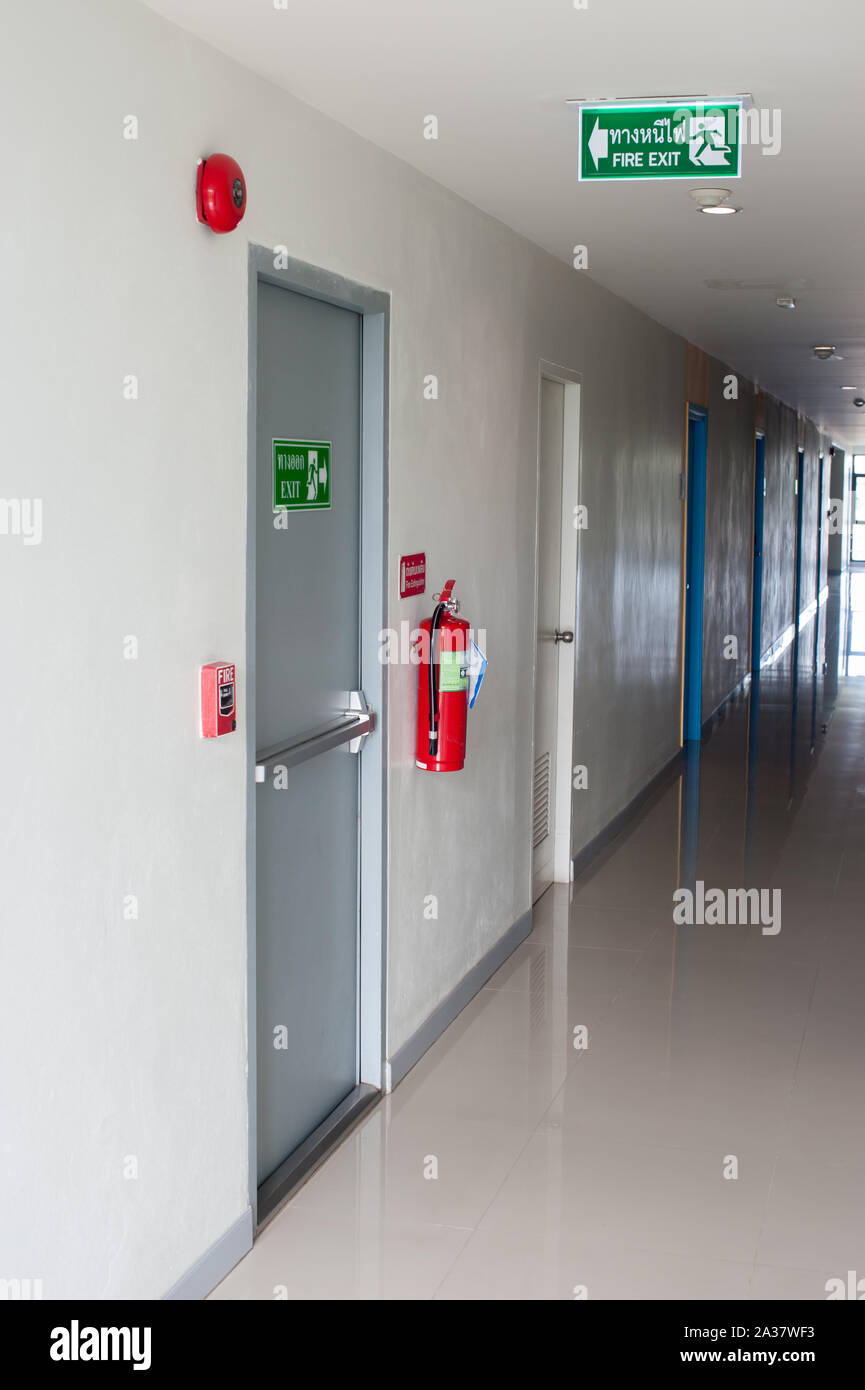 Emergency fire exit sign direction to doorway in the building green