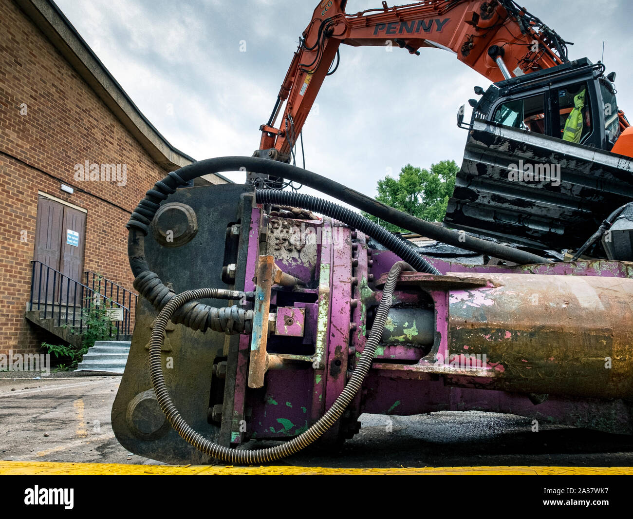 The demolition of an old building using heavy duty industrial machinery. Stock Photo