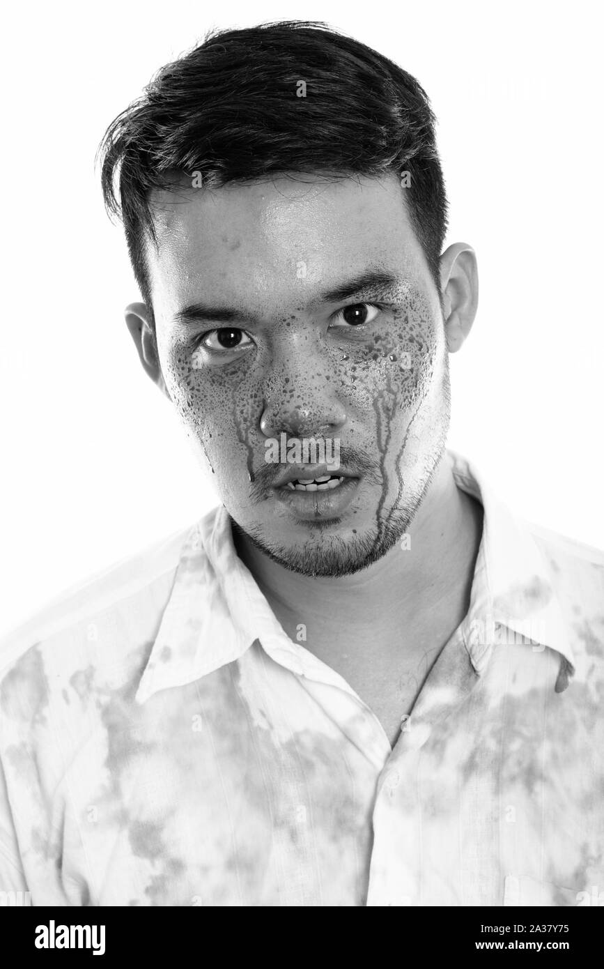 Face of young crazy Asian man with blood on face Stock Photo