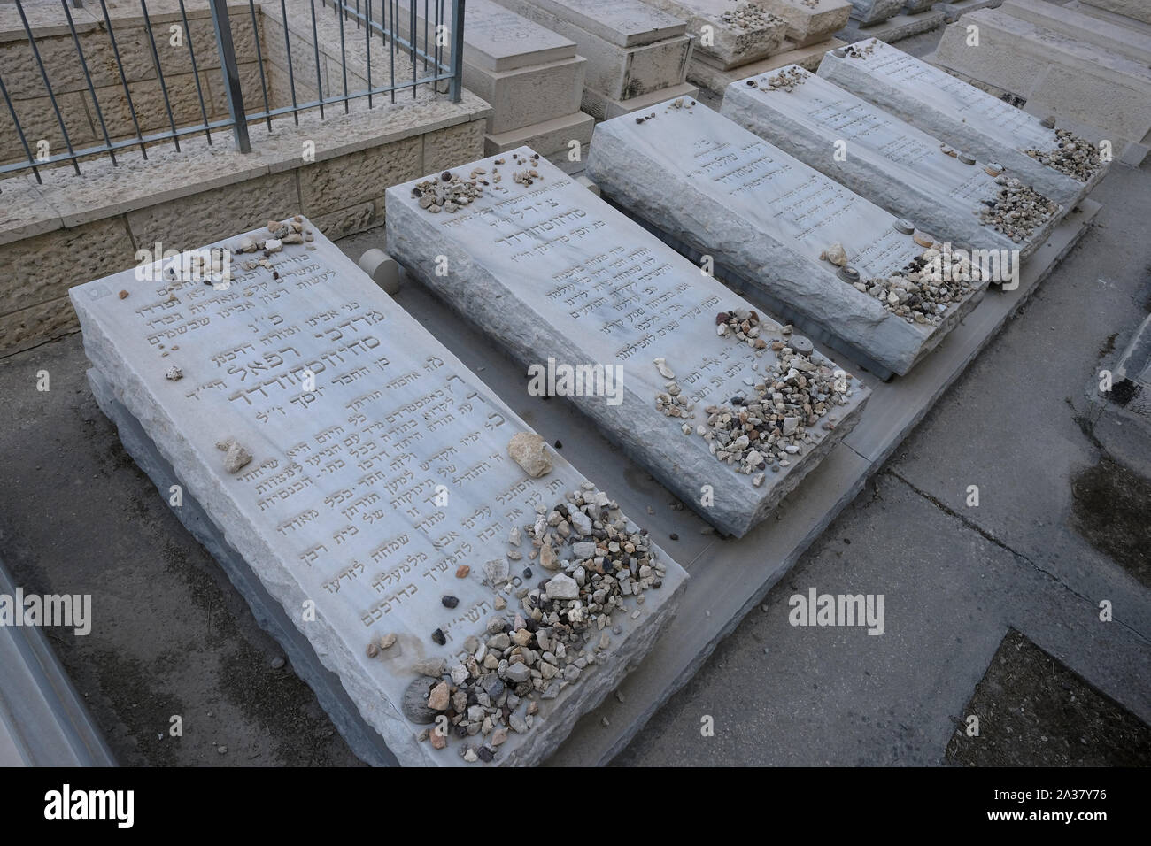Stones placed in sign of gratitude by Jewish visitors according to Jewish tradition on top of the graves of five members of Schijveschuurder Dutch immigrant family killed in the Sbarro restaurant suicide bombing in central Jerusalem, also called the Sbarro massacre on 9 August 2001 in which 15 civilians were killed located in Har HaMenuchot also known as Givat Shaul Cemetery in West Jerusalem Israel Stock Photo