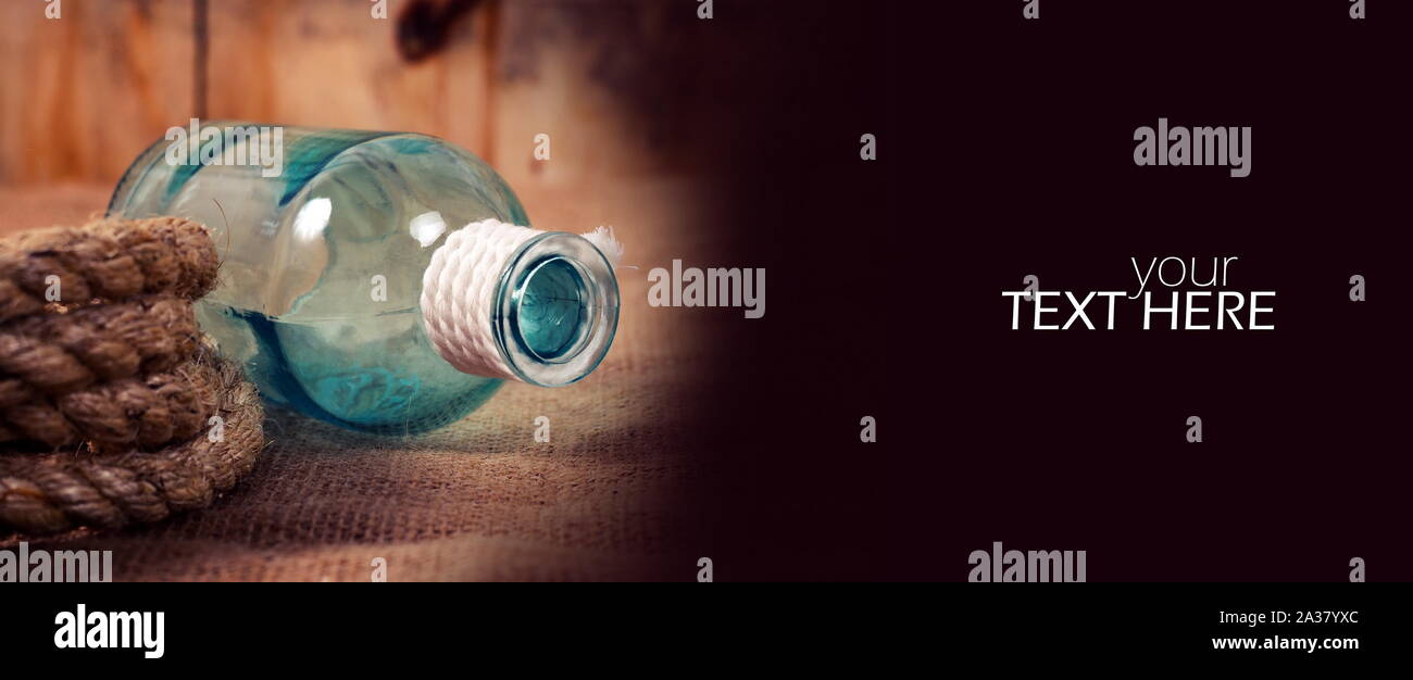 Old style rope with the bottle Stock Photo - Alamy