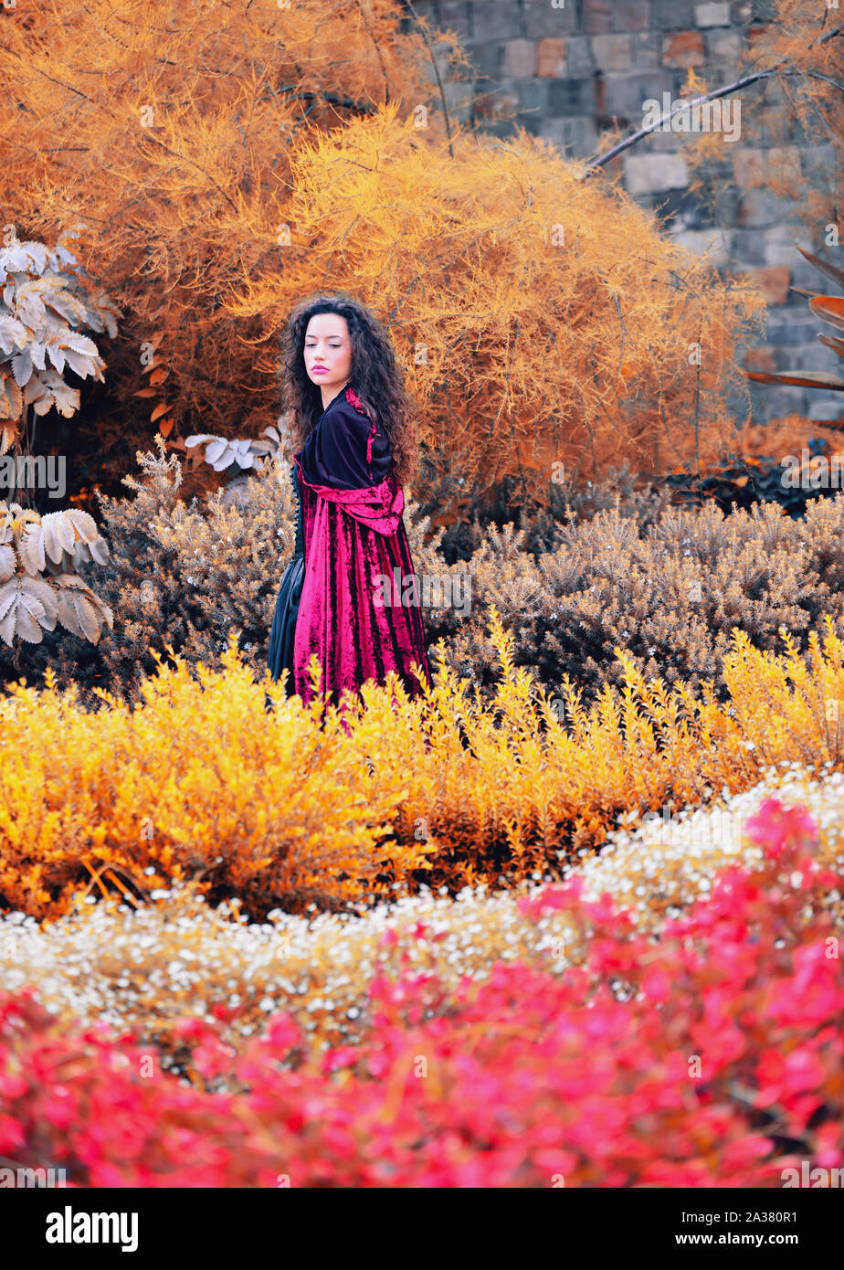 Beautiful young woman wearing a cloak in nature Stock Photo
