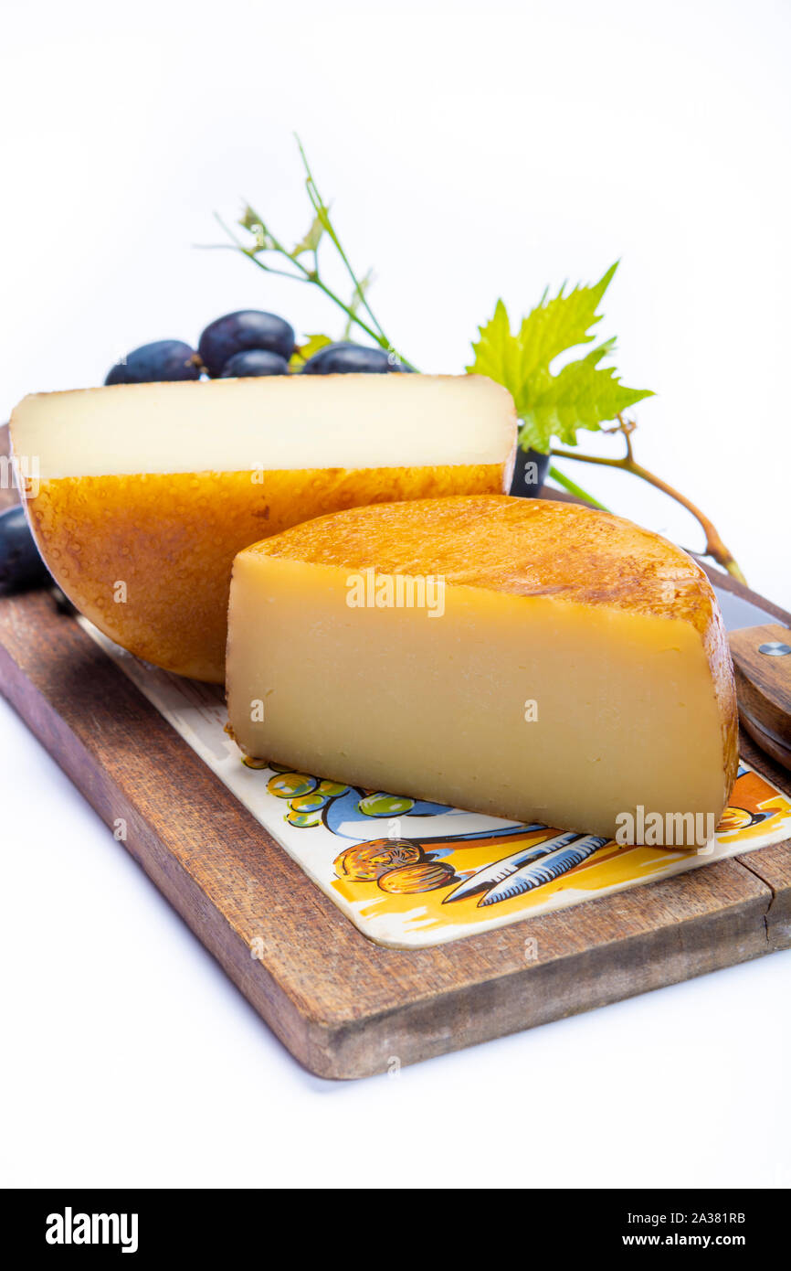 Hard Italian pecorino sheep cheese in two pieces close up isolated