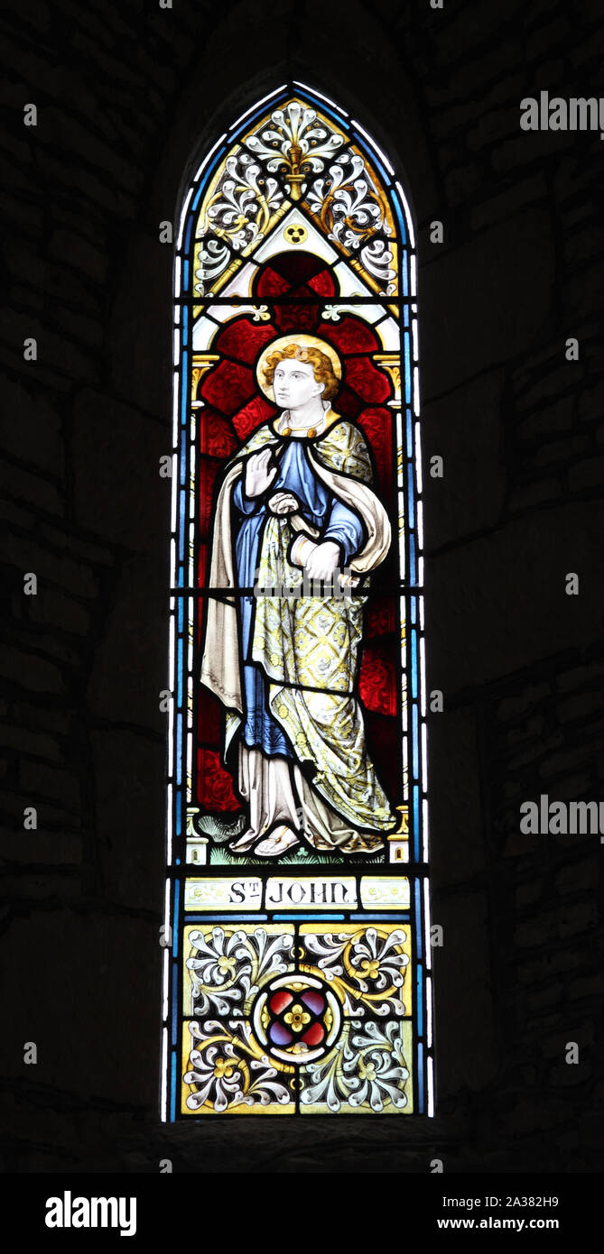 A stained glass window depicting St John The Evangelist, Whitchurch Church, Warwickshire Stock Photo