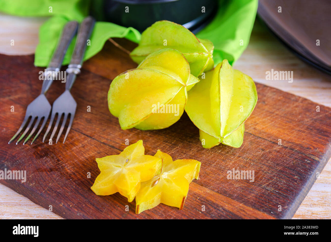 Exotic  starfruit  or averrhoa carambola on wooden cut board. Healthy food, fresh organic star apple fruit. Carambolas background Stock Photo