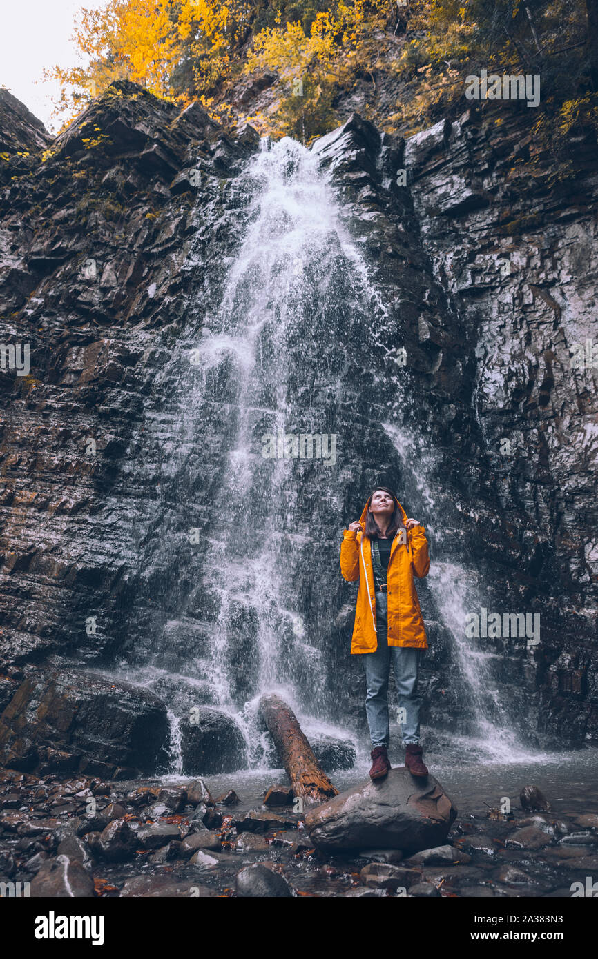 Cheerful woman in yellow raincoat hi-res stock photography and images ...