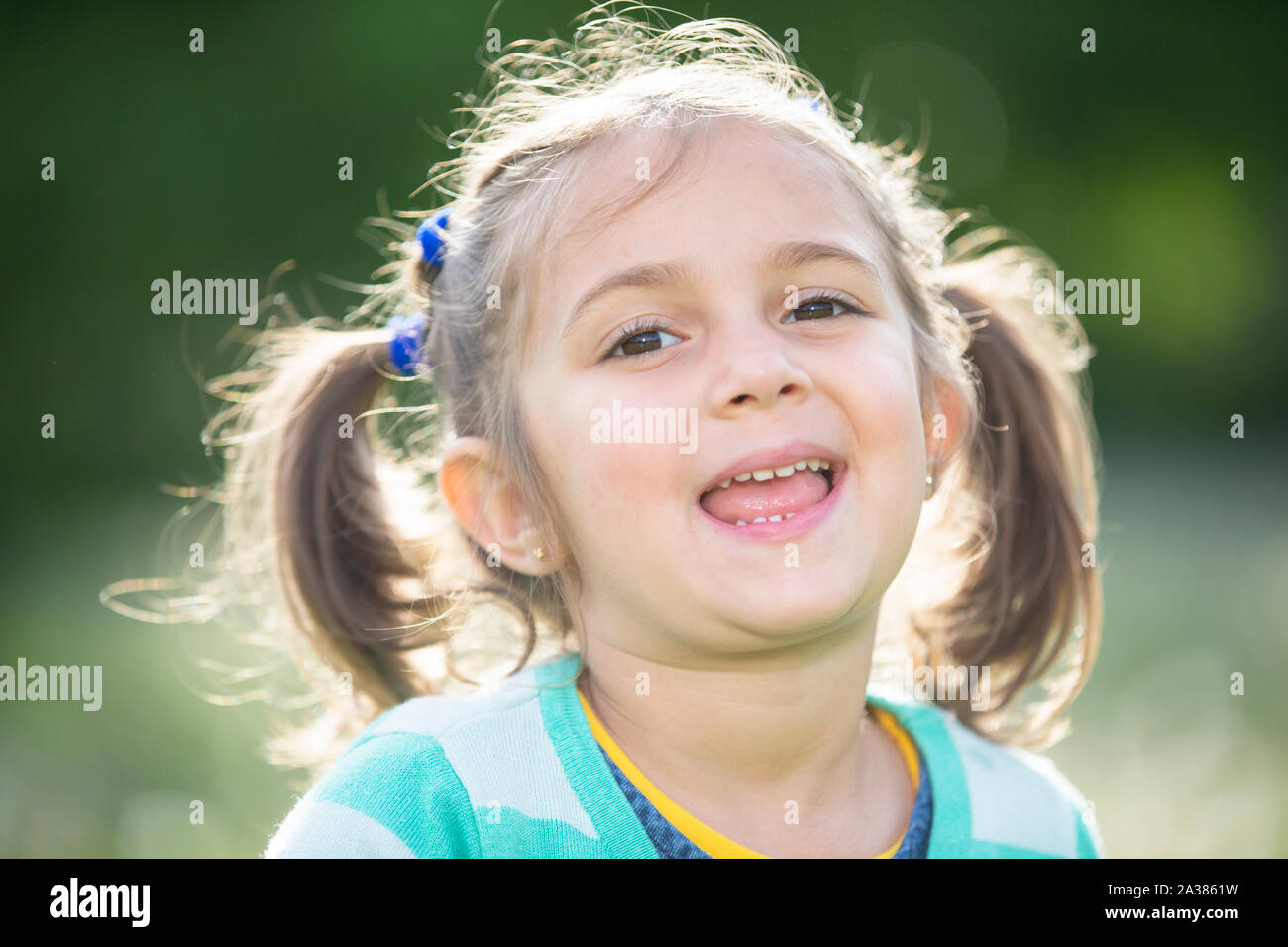 Portrait of a laughing preschool girl. The face of a five year old