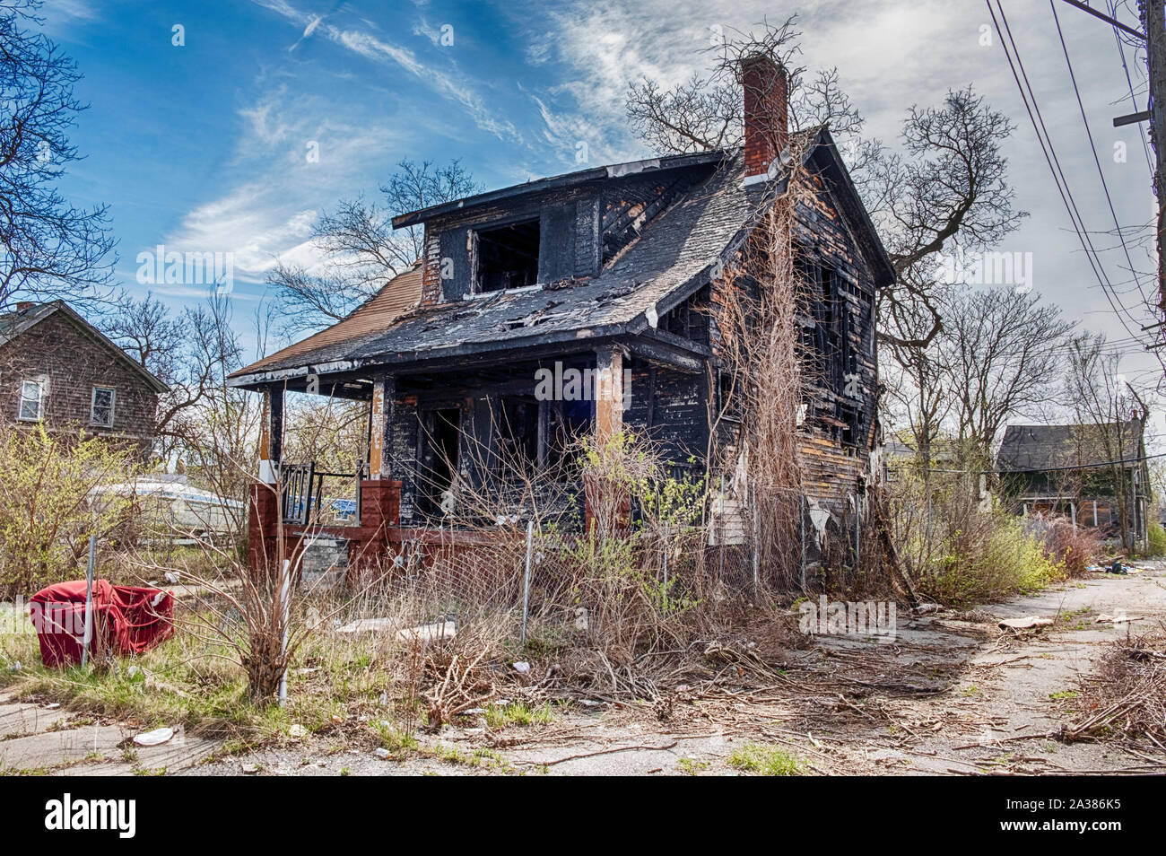 DETROIT, MICHIGAN - APRIL 27, 2019:  An old house in Detroit is blackened with smoke damage after having sustained a fire. Stock Photo