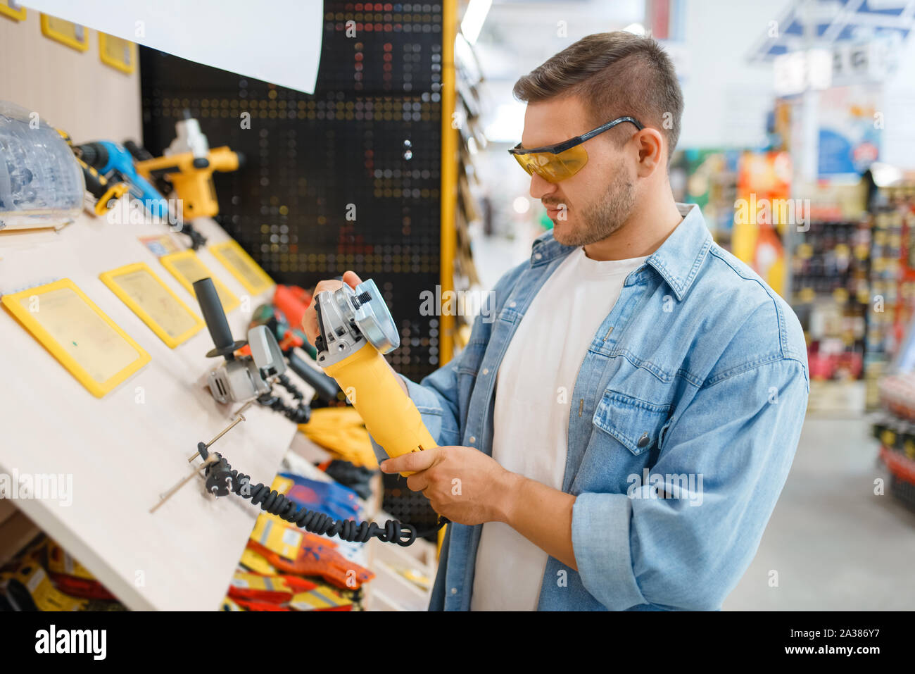 Buyer holding edging machine in hardware store Stock Photo