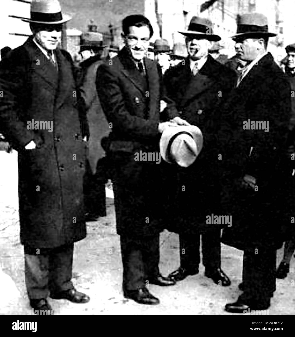 1930 periodical illustration - Law & Order in the USA -  A full length portrait of the always dapper 'The Jersey Kid' (2nd from left) soon after his capture Stock Photo