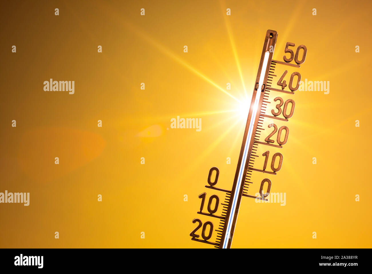 Hot summer or heat wave background, bright sun with thermometer Stock Photo