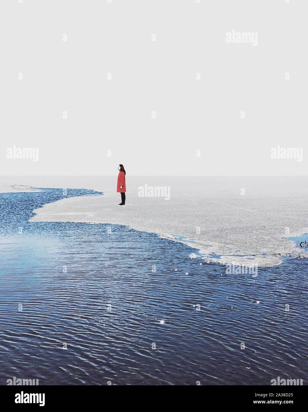 Woman standing on ice at the edge of a lake, South Korea Stock Photo