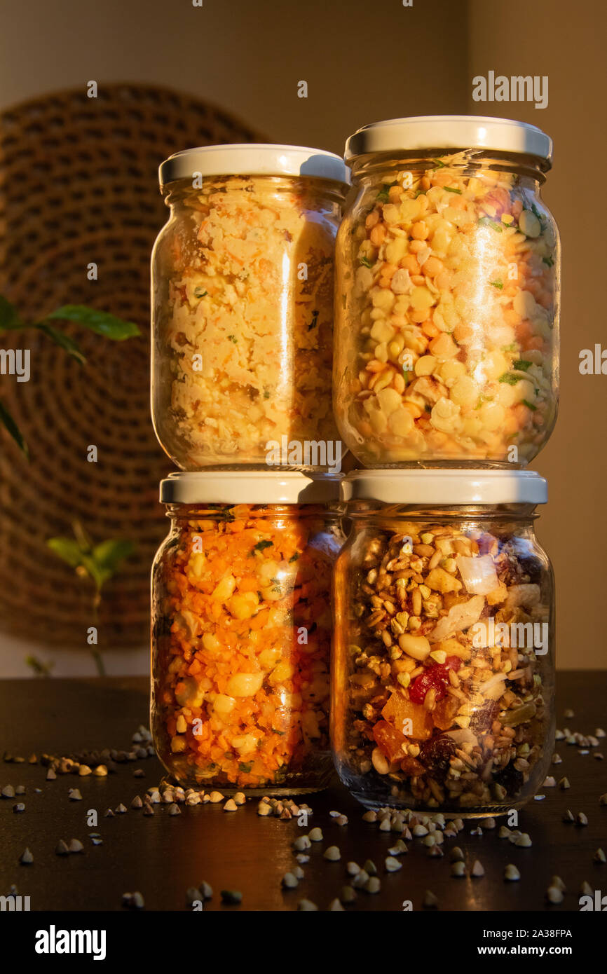Jars of fresh  lentils, granola, nuts and seeds Stock Photo