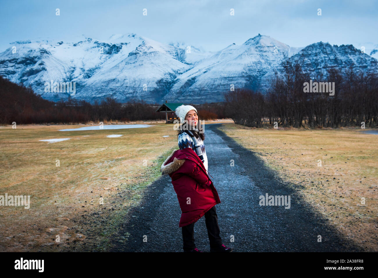 Female traveler walking on a scenic road in Iceland Stock Photo