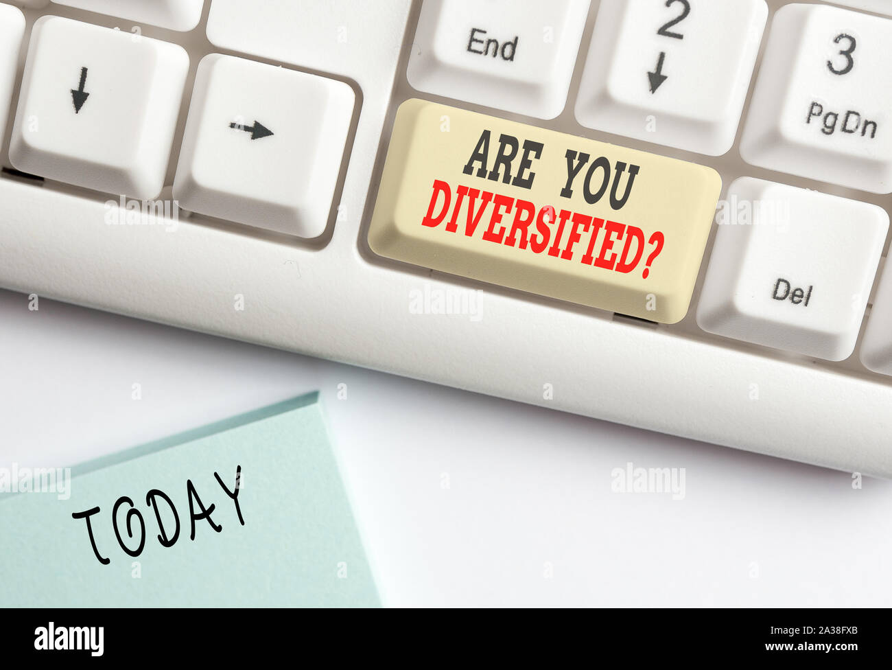 Conceptual hand writing showing Are You Diversified Question. Concept meaning someone who is Different Mixed Multi Faceted White pc keyboard with note Stock Photo