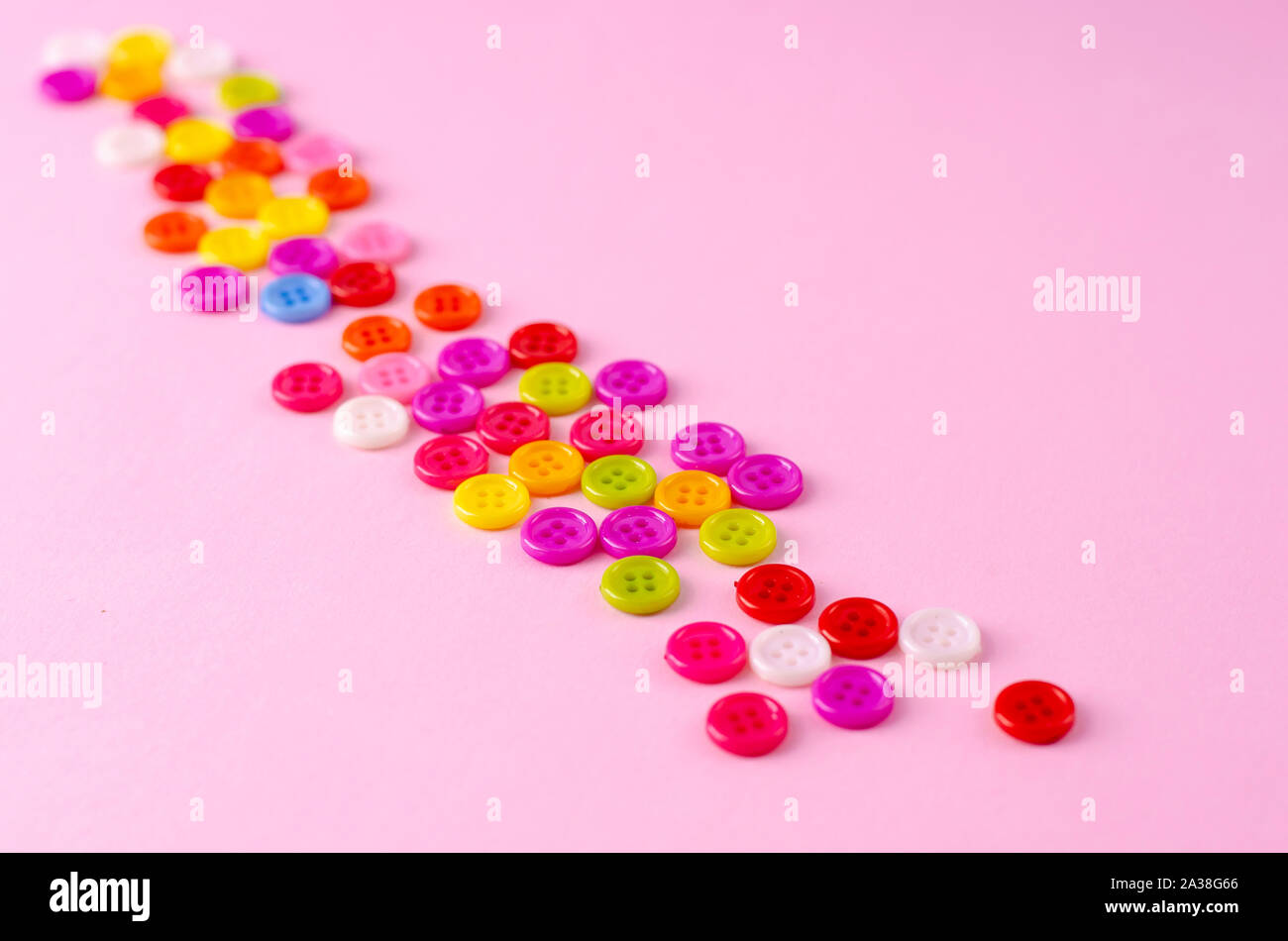 Many colorful buttons on blue background. Selective focus. Copy space Stock Photo