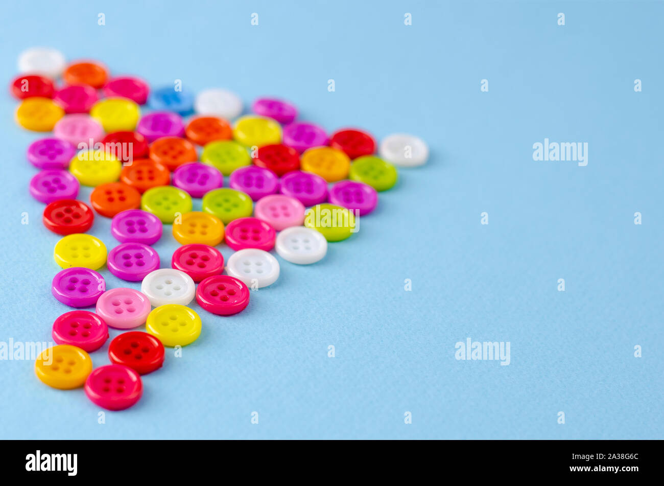 Many colorful buttons on blue background. Selective focus. Copy space Stock Photo