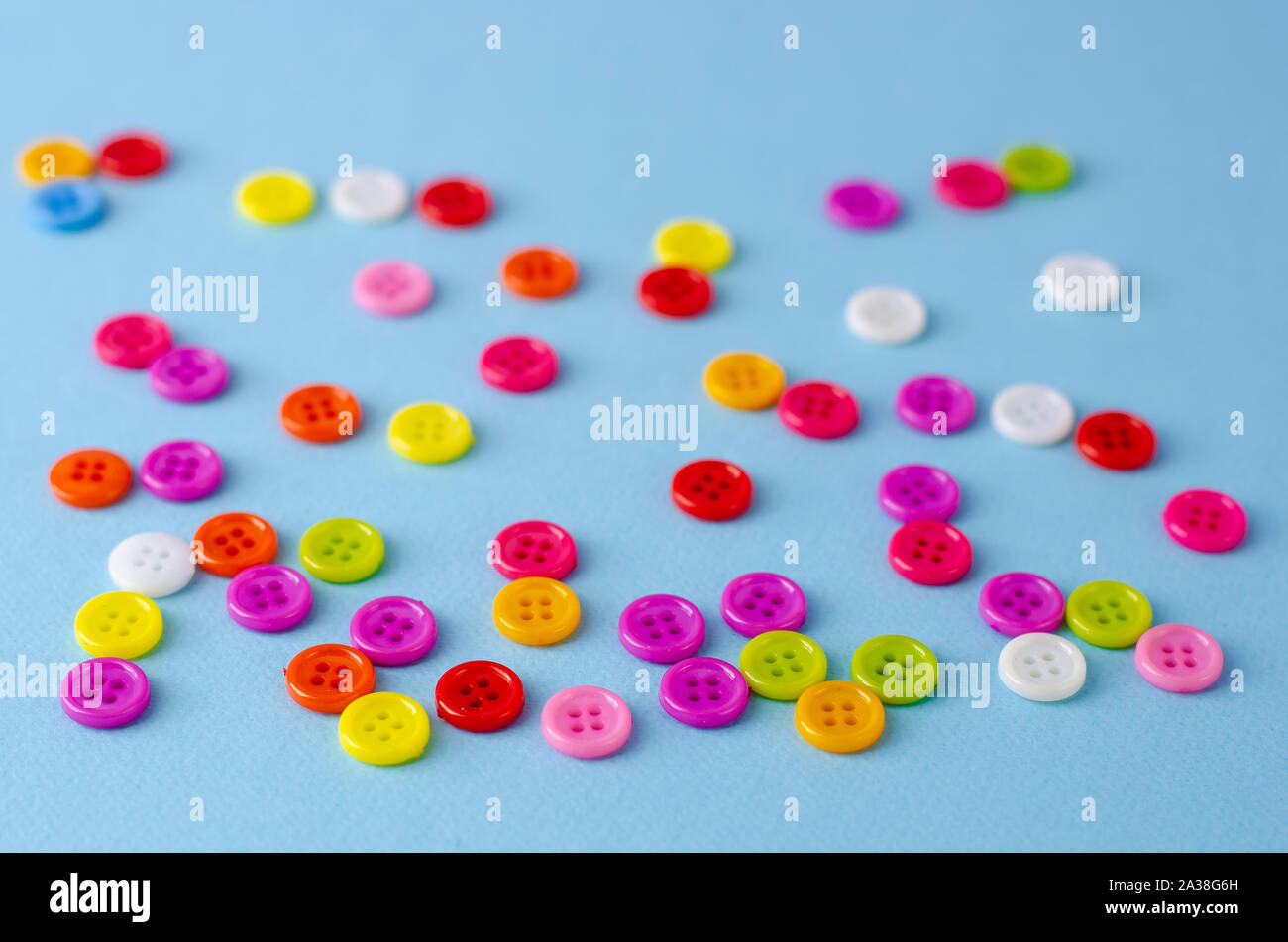 Many colorful buttons on blue background. Selective focus. Stock Photo