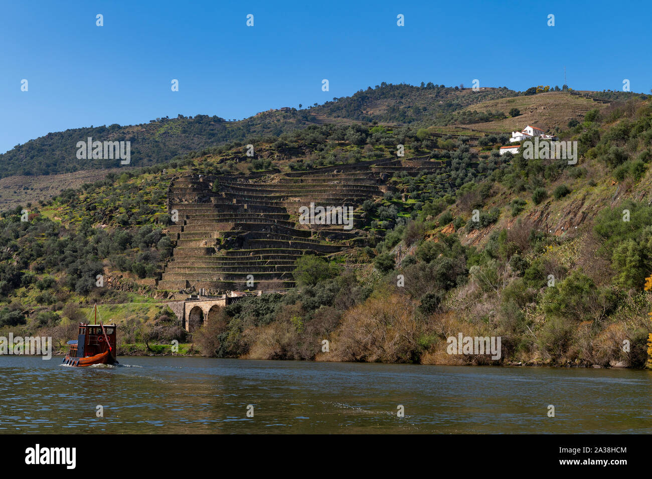 Scenic view of the Douro River with a traditional rabelo boat and terraced vineyards near the Tua village, in Portugal. Stock Photo
