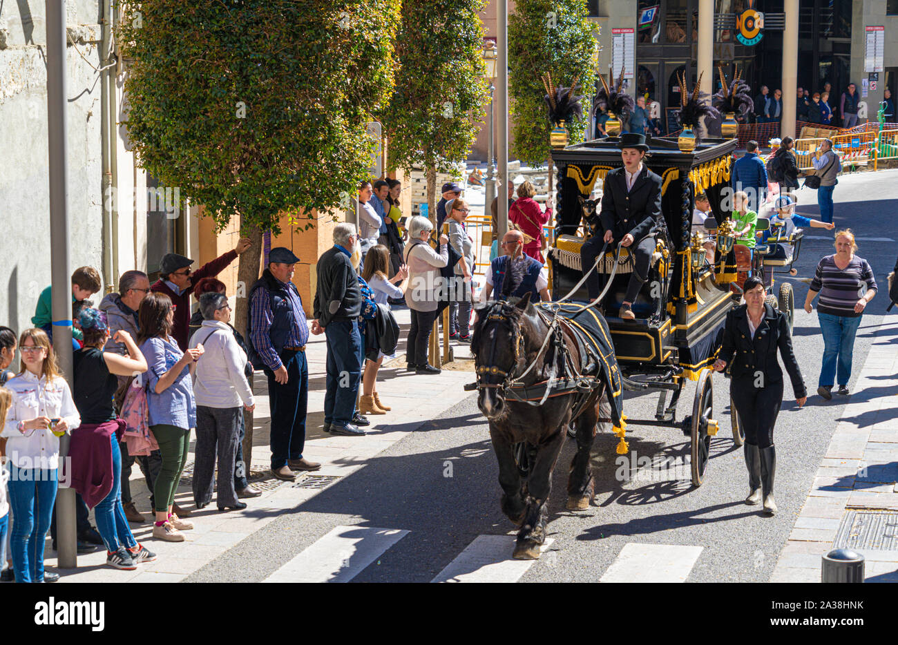 Reus, Spain. March 2019: vintage dressed people on top of a horse-drawn carriage The Tres Tombs festival cavalcade Stock Photo