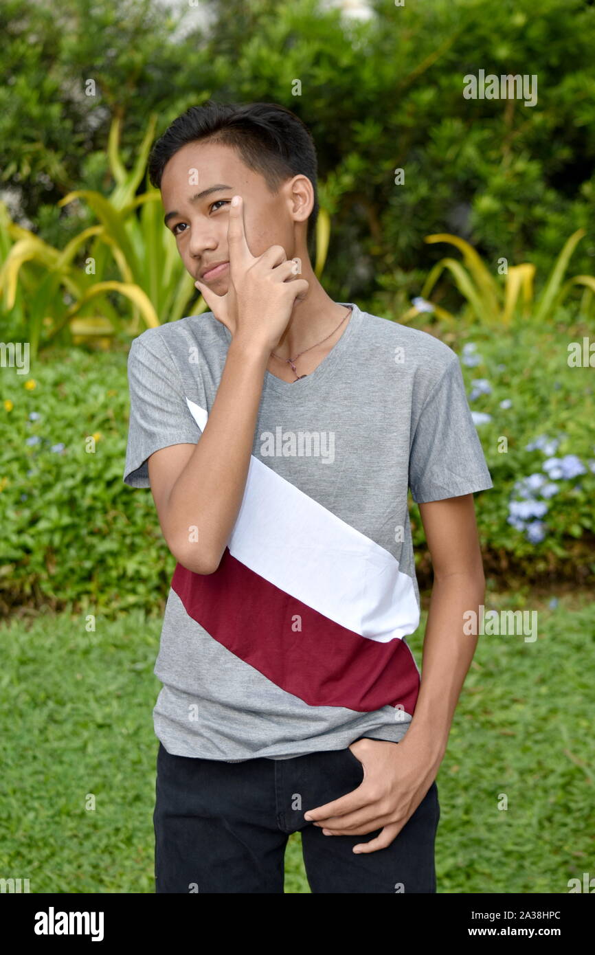 A Young Asian Boy Thinking Stock Photo