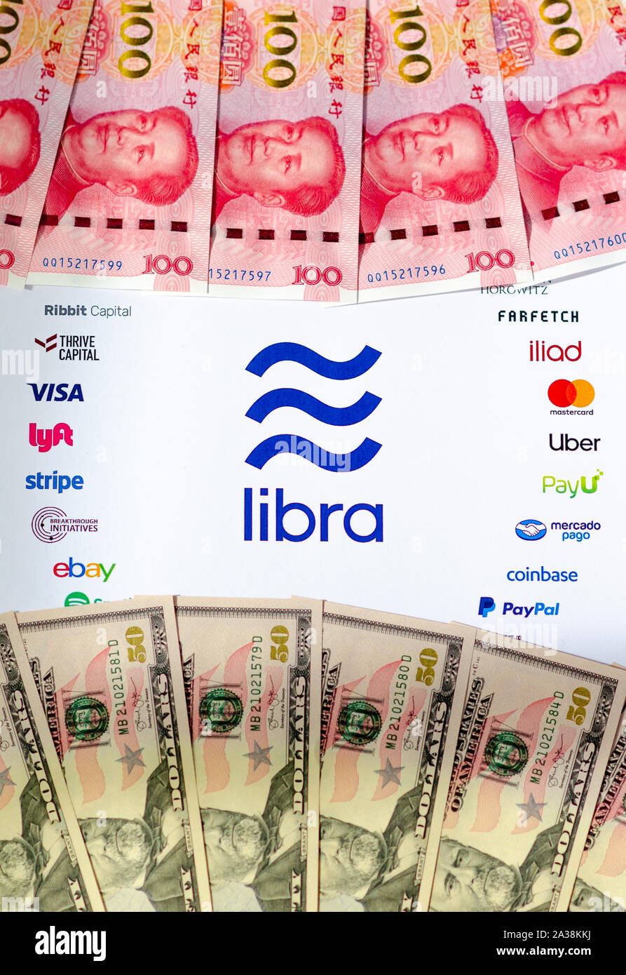 Stone, Staffordshire / UK - October 6 2019: Libra Association logo on a brochure with USD and CNY banknotes. Photo with selective focus. Stock Photo