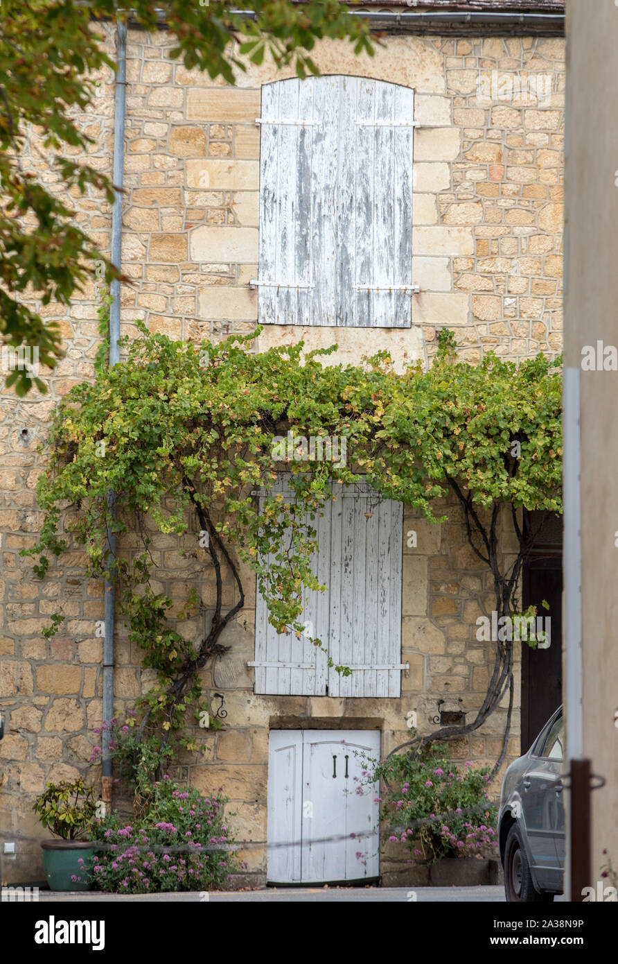 Old stone house with wooden shutters in Domme. Perigord, France Stock ...