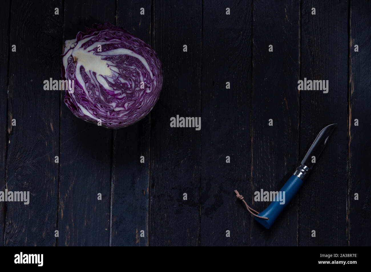 Sliced cabbage with a knife. Purple cabbage and a blue knife. Kitchen