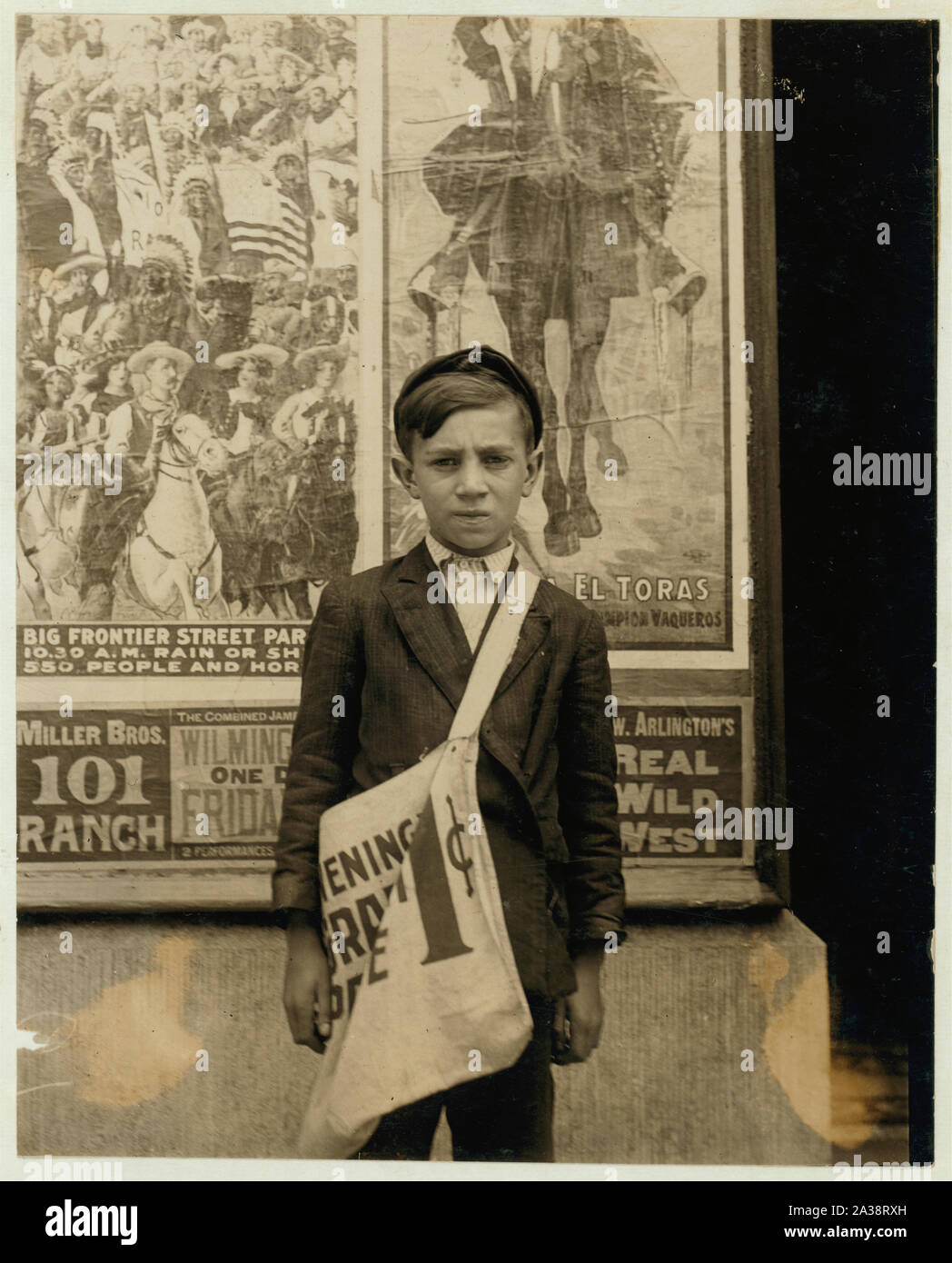 S. Russell, 33 E. 22nd St. Newsboy, 12 years of age. Selling newspapers 2 years. Average earnings 20 cents daily. Selling newspapers own choice. Father earns $18 weekly. Boy deposits earnings in du Pont Savings Bank, and on Saturday night works for Reynold's candy shop, delivering packages. Don't smoke. Visits saloons. Works 5 hours daily, except Saturday, when he works 11. Stock Photo
