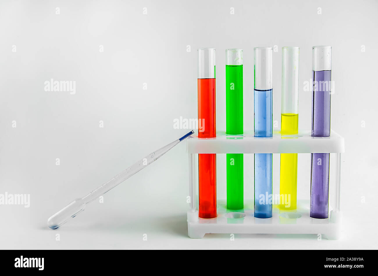 test tubes with multi-colored reagents on a white background. chemistry ...