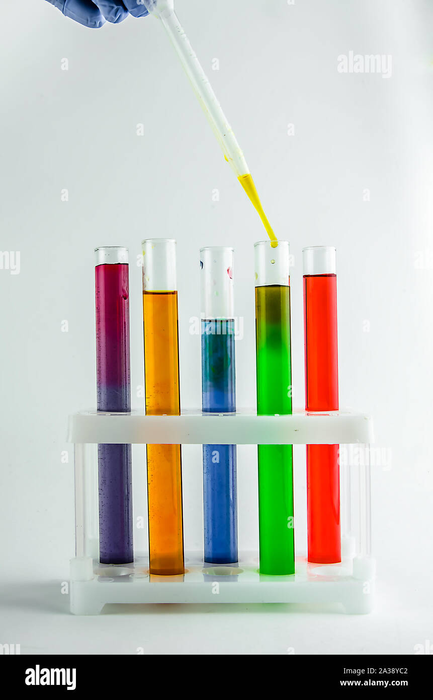 test tubes with multi-colored reagents on a white background. chemistry ...