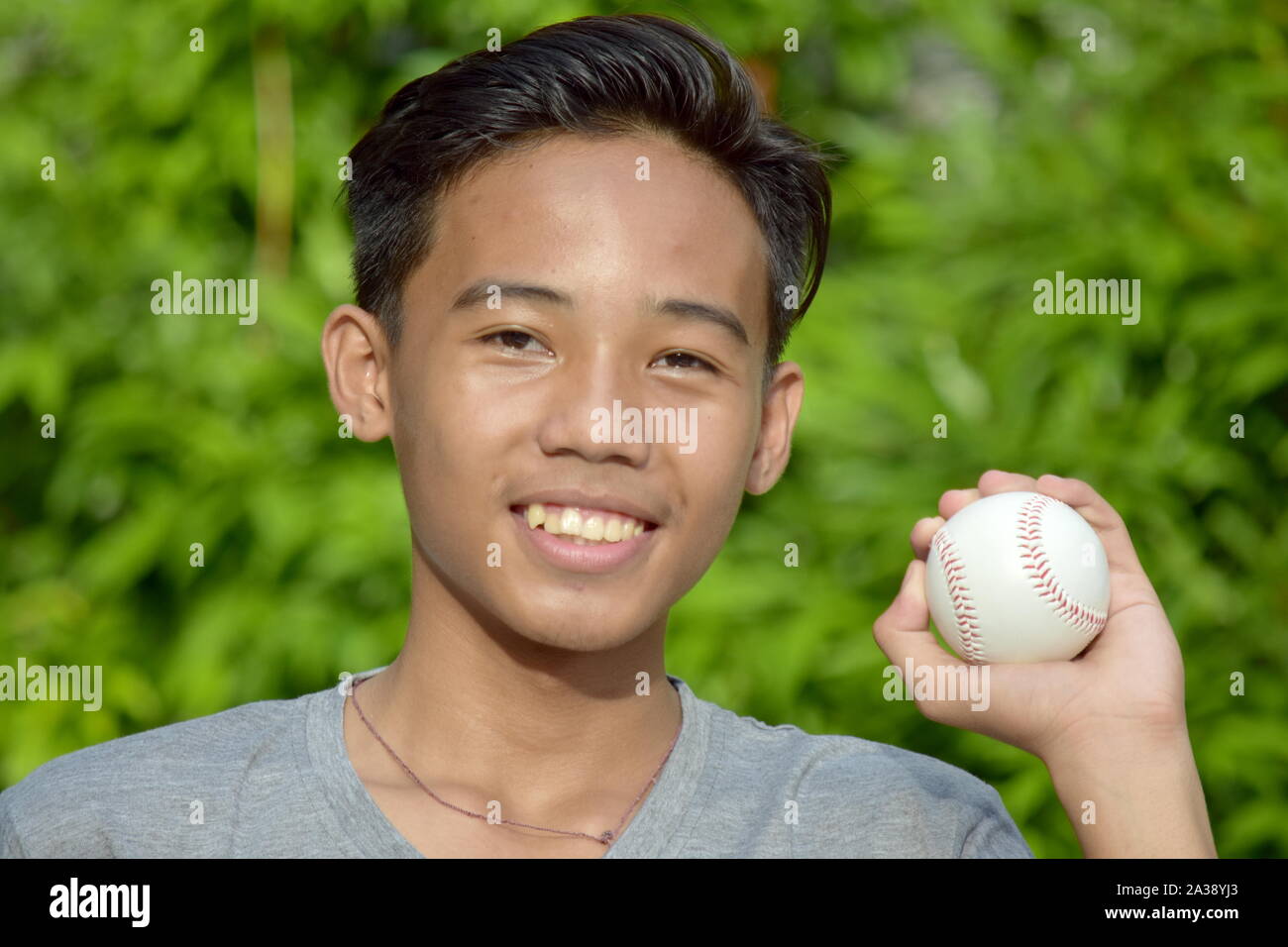 Minority Male Athlete And Happiness With Baseball Stock Photo