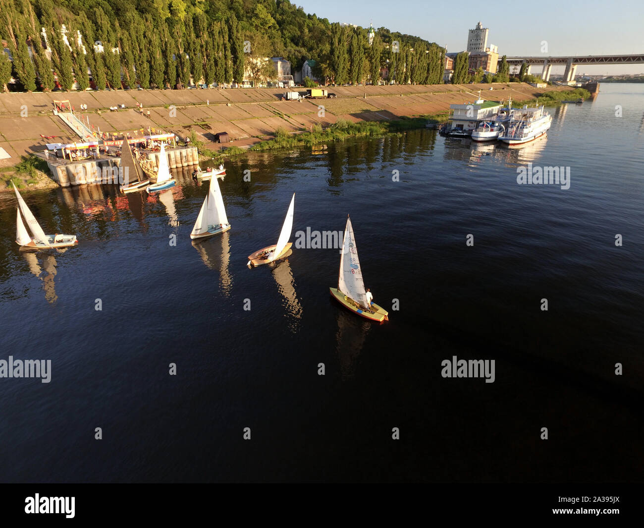 Volga river. Single-masted yacht takes a walk along the river. Stock Photo