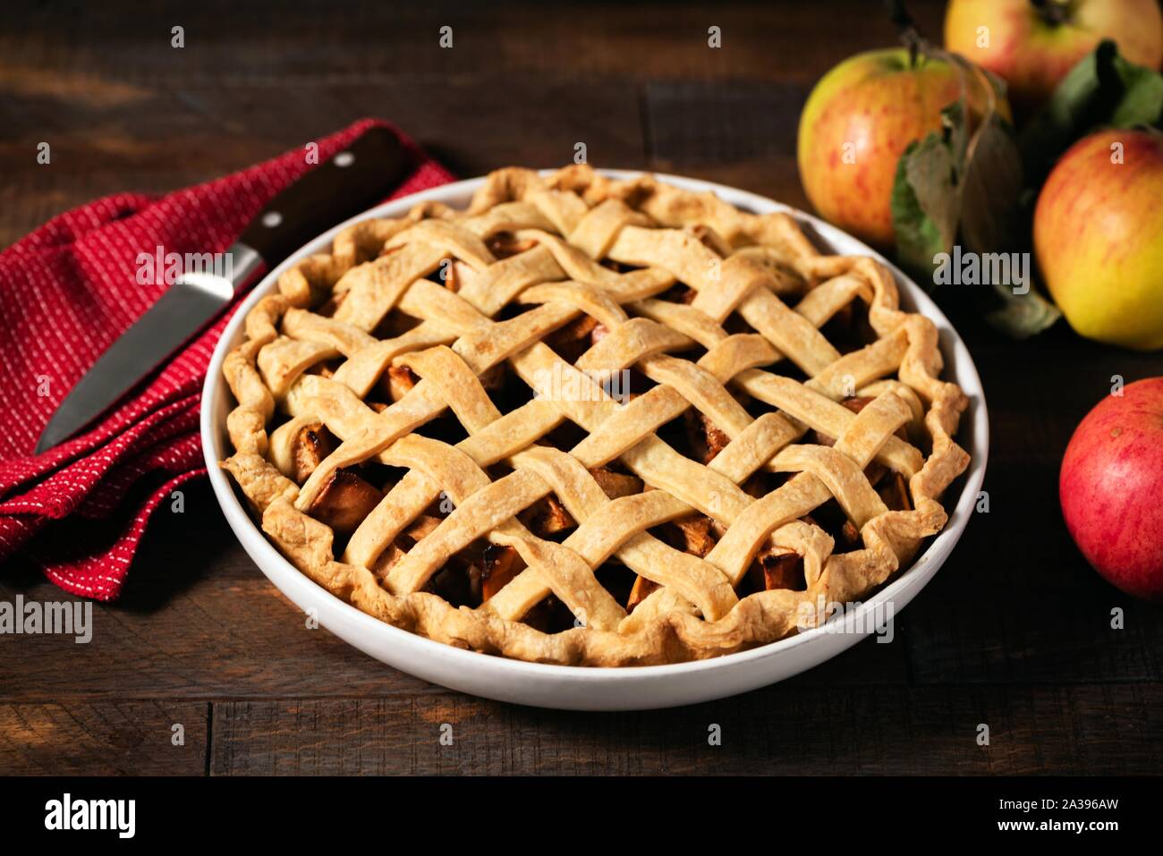 Homemade apple pie with lattice crust top on a rustic wooden table Stock Photo