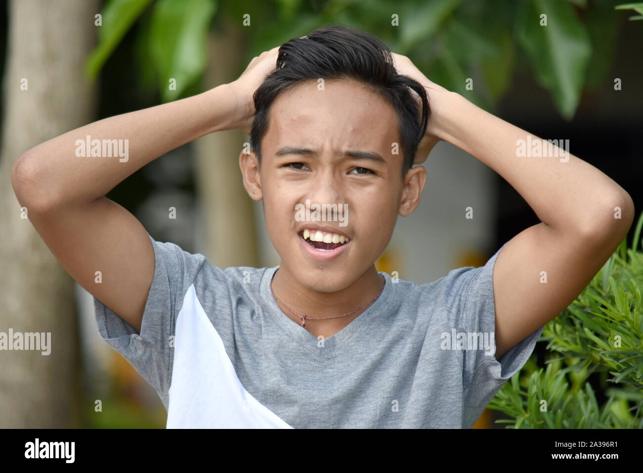 A Confused Young Asian Boy Stock Photo