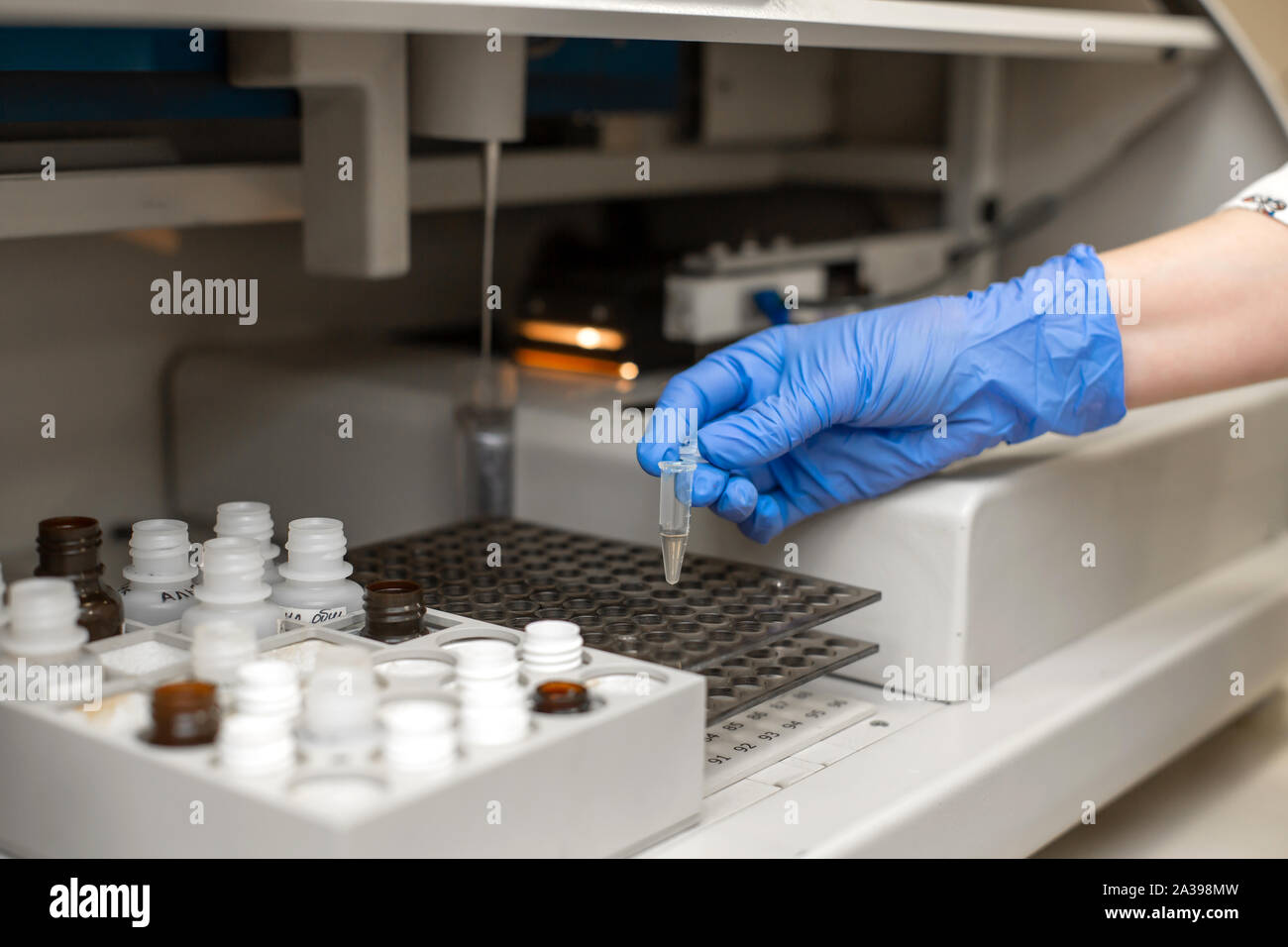 Laboratory technician test blood in automatic blood sample analyzer