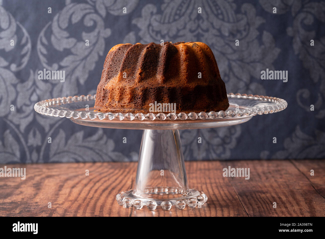 Marbled Bunt Cake, Red Wine with Dark Blue Damask Background Stock Photo