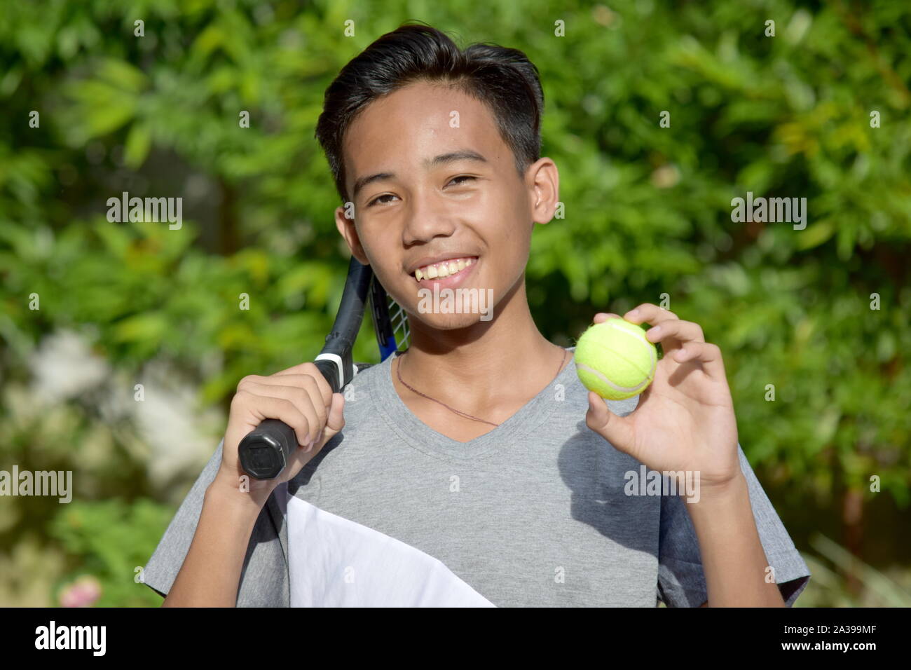 Fitness Filipino Tennis Player Smiling With Tennis Racket Stock Photo