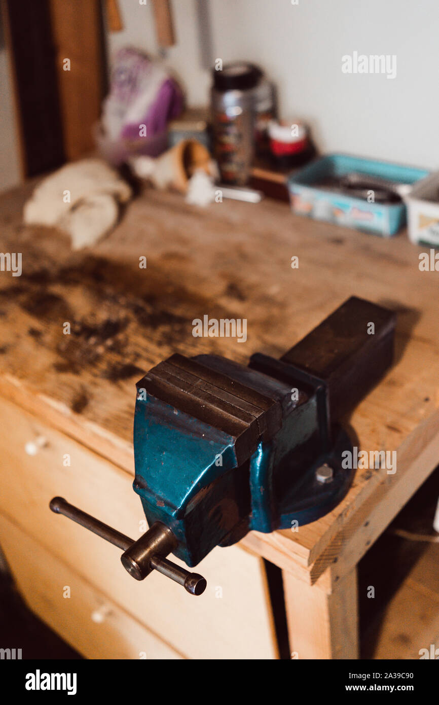 Blue Metal Vise fixed to a work table Stock Photo