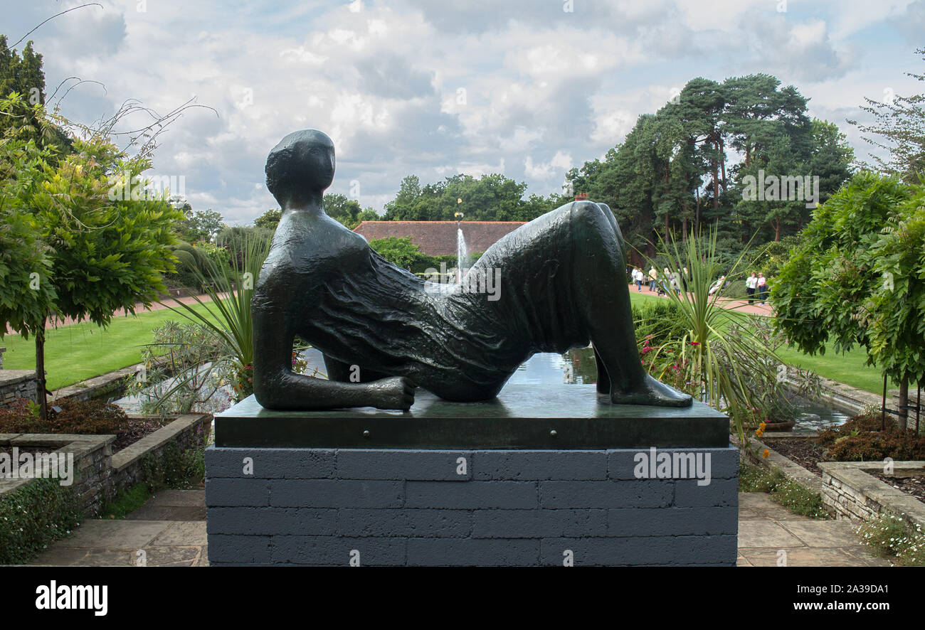 Bronze sculpture by Henry Moore of a reclining draped woman by the