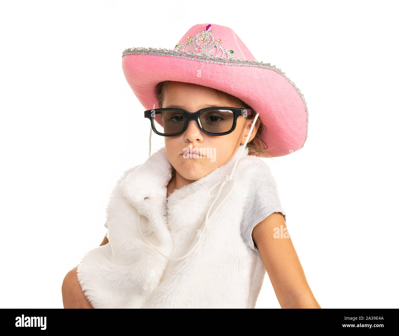 Young girl in cowboy hat and sunglasses posing on a white background. Stock Photo