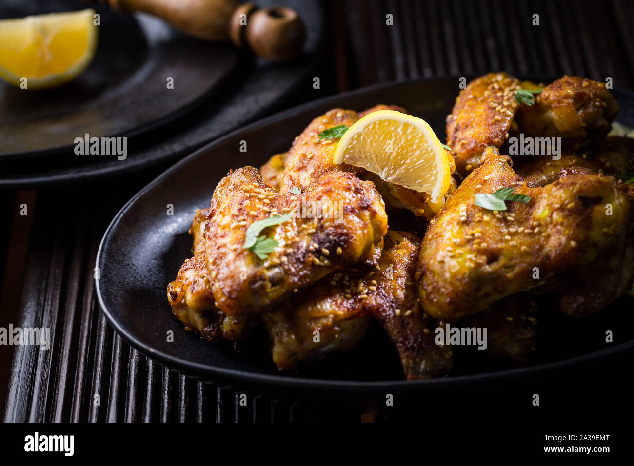 Spicy chicken wings with garlic, sesame and lemon marinade in Asia