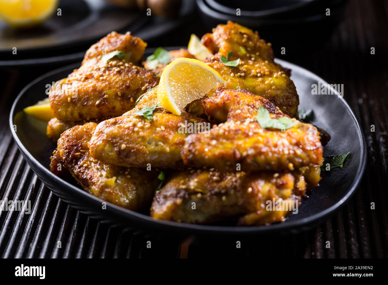 Spicy chicken wings with garlic, sesame and lemon marinade in Asia style Stock Photo