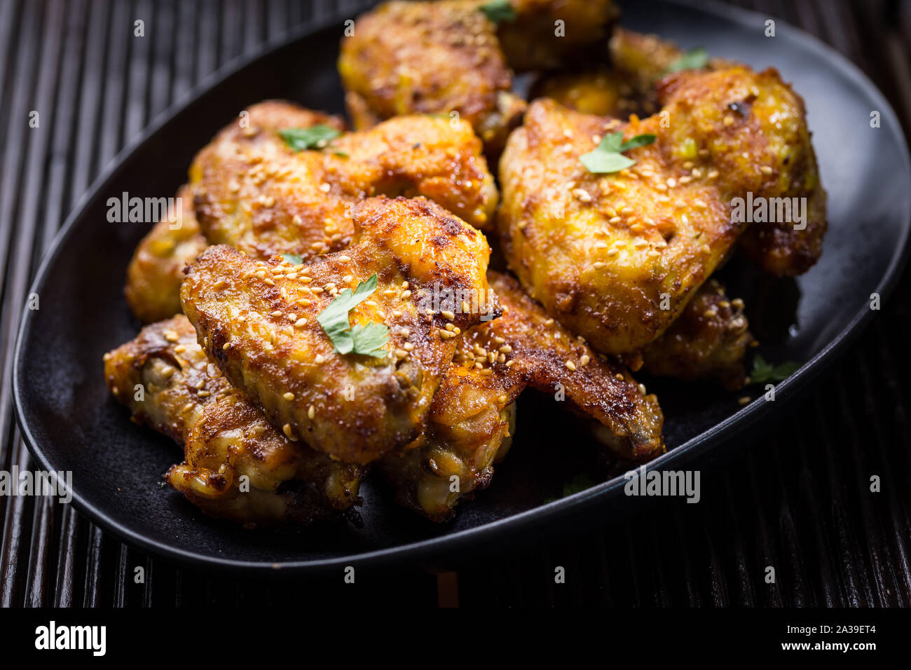 Spicy chicken wings with garlic, sesame and lemon marinade in Asia style Stock Photo